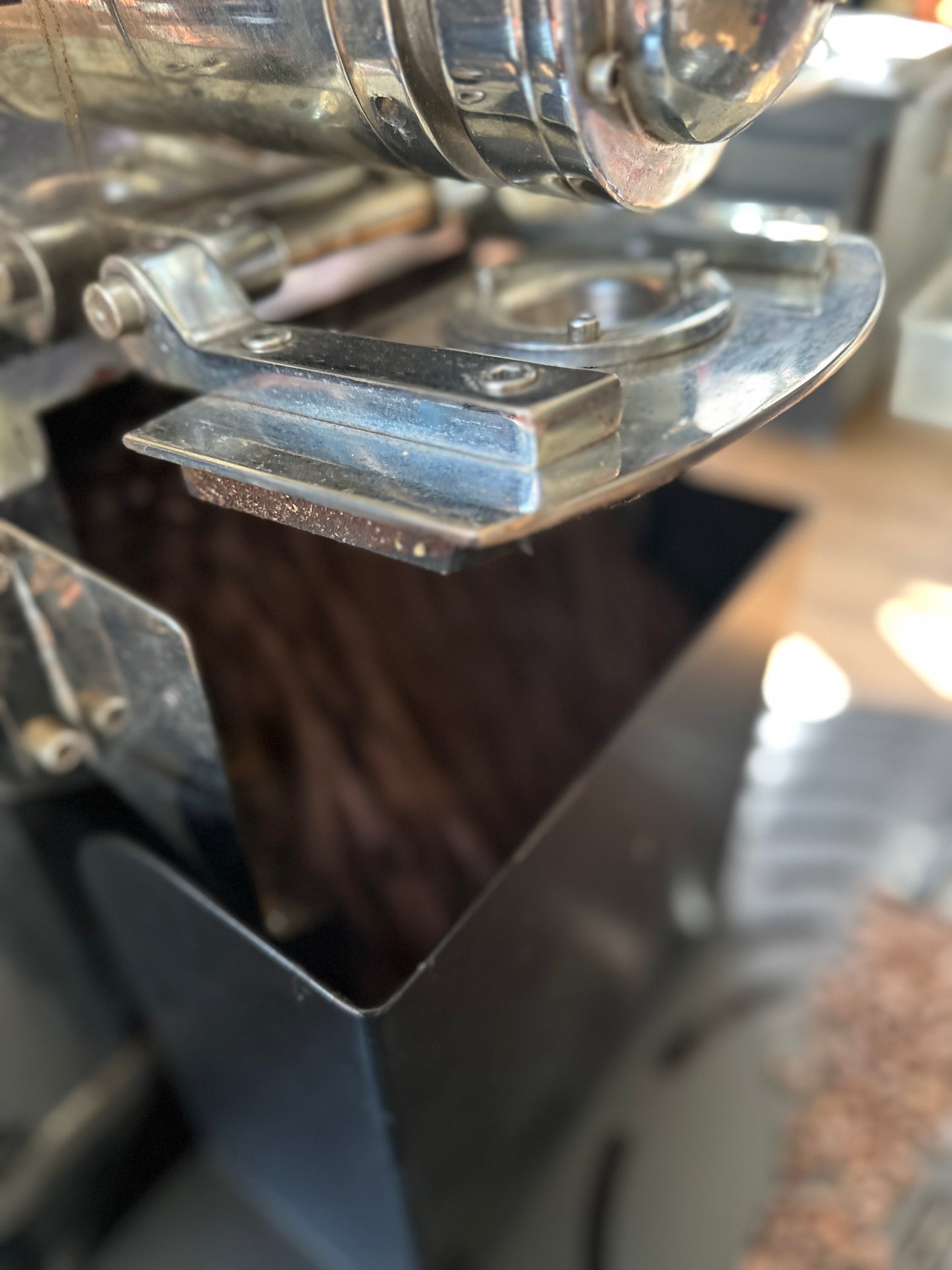 Fresh roasted coffee beans coming out of the roaster drum into the cooling tray