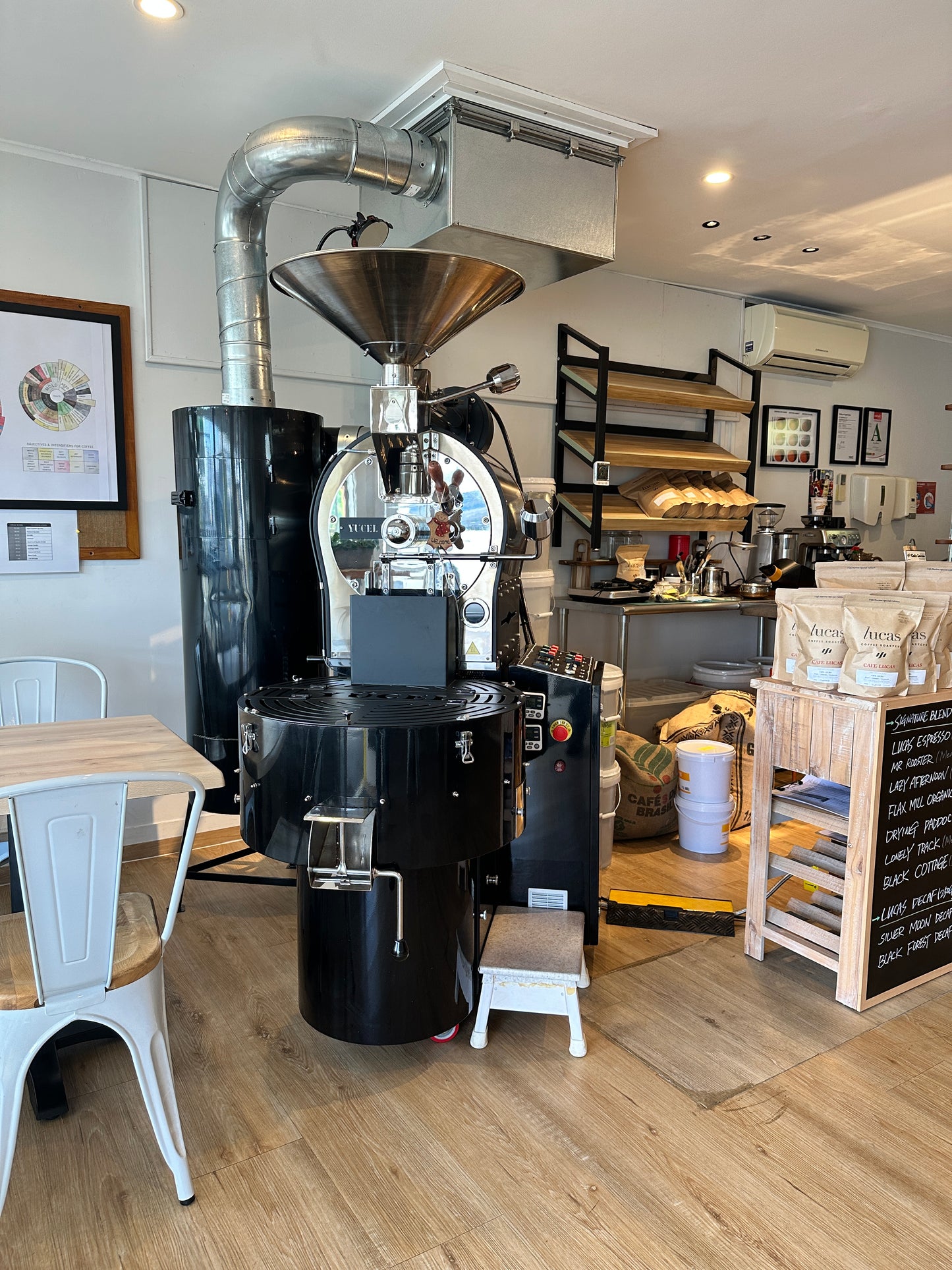Yucel coffee roaster with chaff collector and ducting installed in a café for commercial roasting